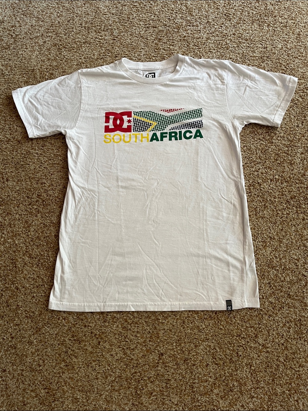 DC White Tee with Red, Yellow, Green and Black South Africa Graphic
